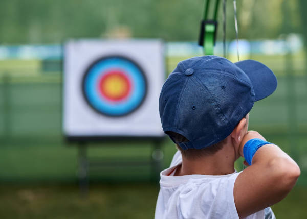 picture of a child about to shoot an arch with a targer board at about 5m distance